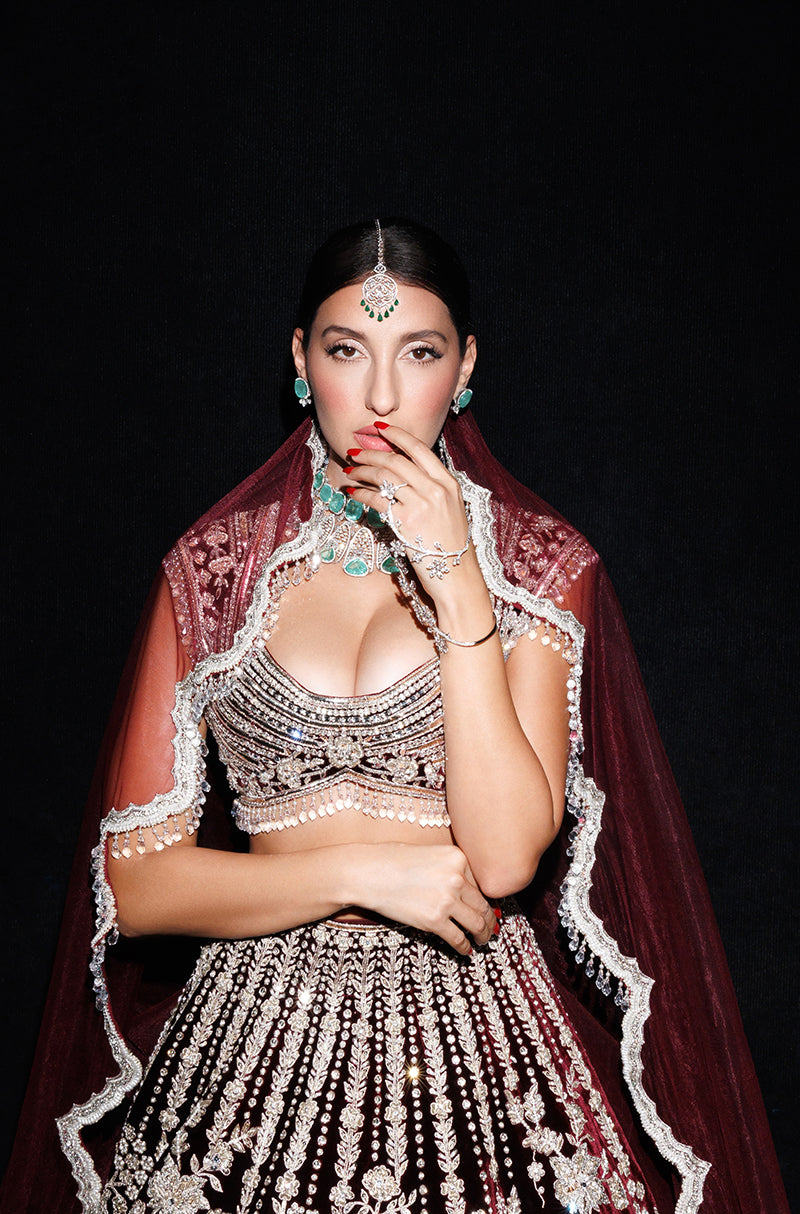 Nora Fatehi in our Garnet Red Velvet Embroidered Lehenga Set