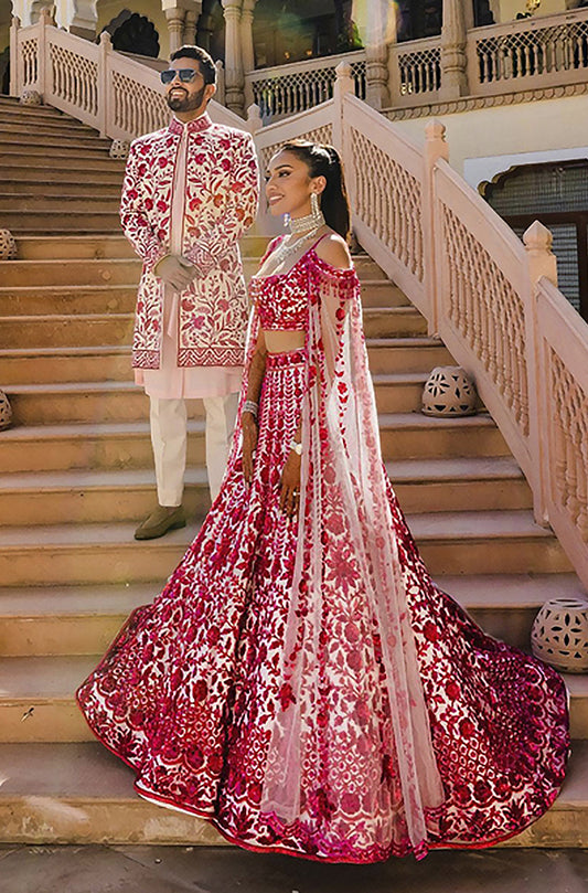 Bride: Raveena & Groom: Saket Mehta Co-ordinating each other in  Red-Pink Threadwork Ensemble