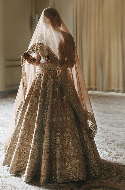Bride: Ramneek Sodhi in Peach Gold Embroidered Lehenga Set